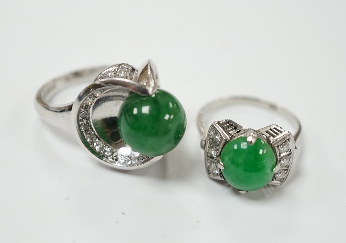 A modern white metal (stamped Pt) and jade bead set ring, with diamond set shoulders, size J/K, together with a similar larger white metal jade bead and diamond set ring, size I/J, gross weight 19.9 grams. Condition - fa